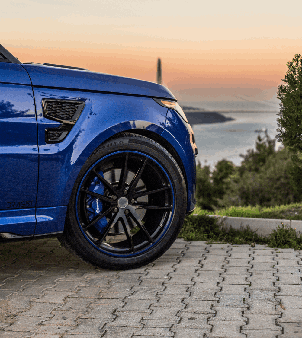 Front right wheel of a blue jeep.