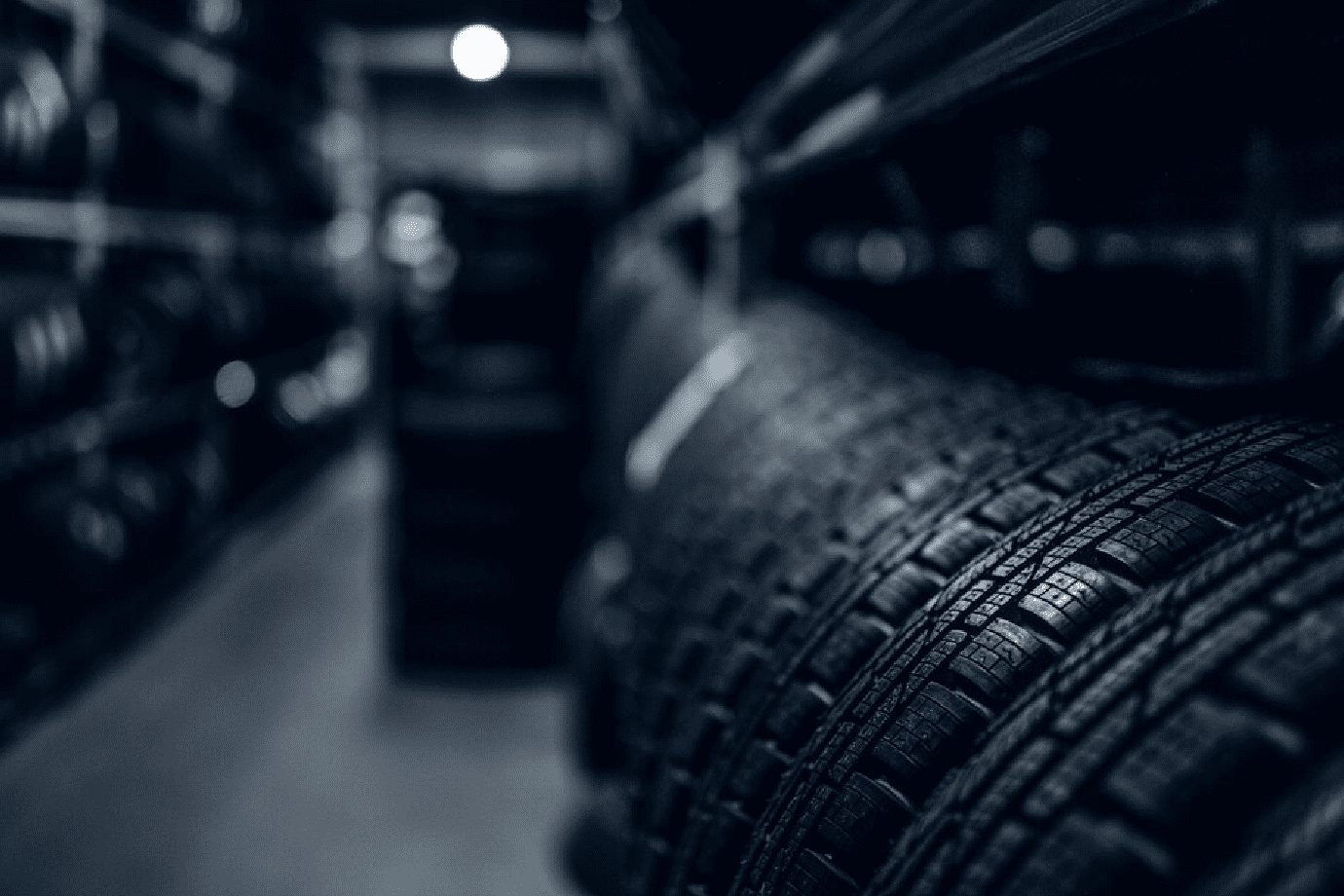 Dark storage full or big variety of new tyres at busy warehouse.<br />
