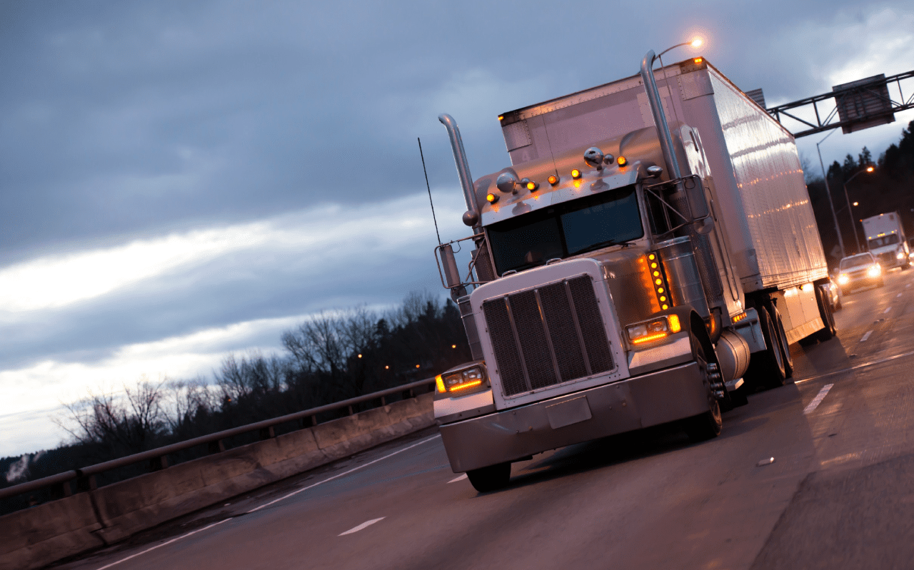 Truck on the highway at night. Concept of cargo transportation.